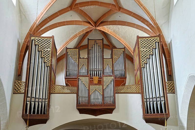 Close-up of an impressive church organ with ornate wooden details and arch structures, parish church of St.Stephan Tulln Lower Austria Austria