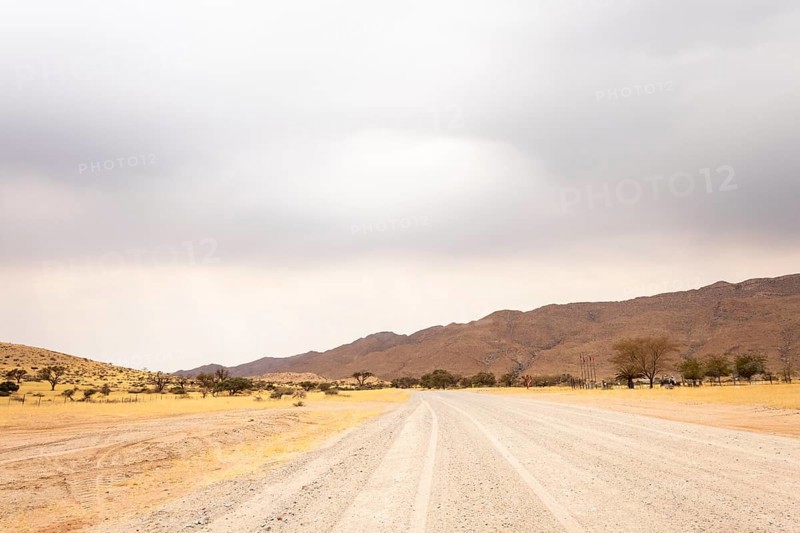Dirt Road in Solitaire, Namibia, located on the edge of the Namib Desert, surrounded by dunes and mountain ranges