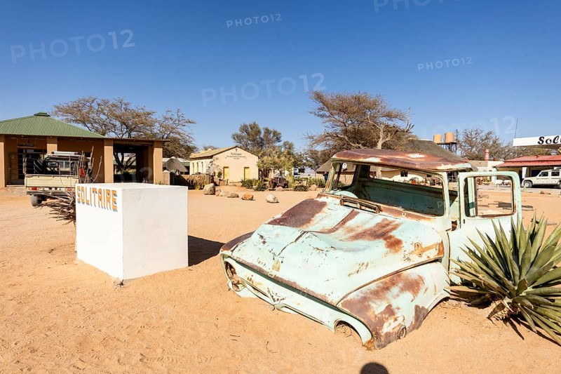 Solitaire's car graveyard in Namibia - 27 August, 2025: features rusted vintage cars near small desert buildings, set against dunes and mountains, capturing desert charm and isolation