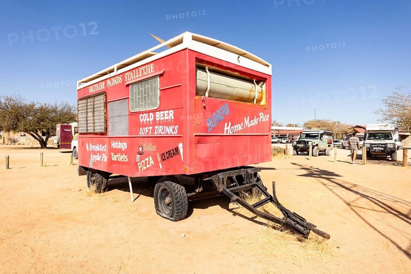 Solitaire's car graveyard in Namibia - 27 August, 2025: features rusted vintage cars near small desert buildings, set against dunes and mountains, capturing desert charm and isolation