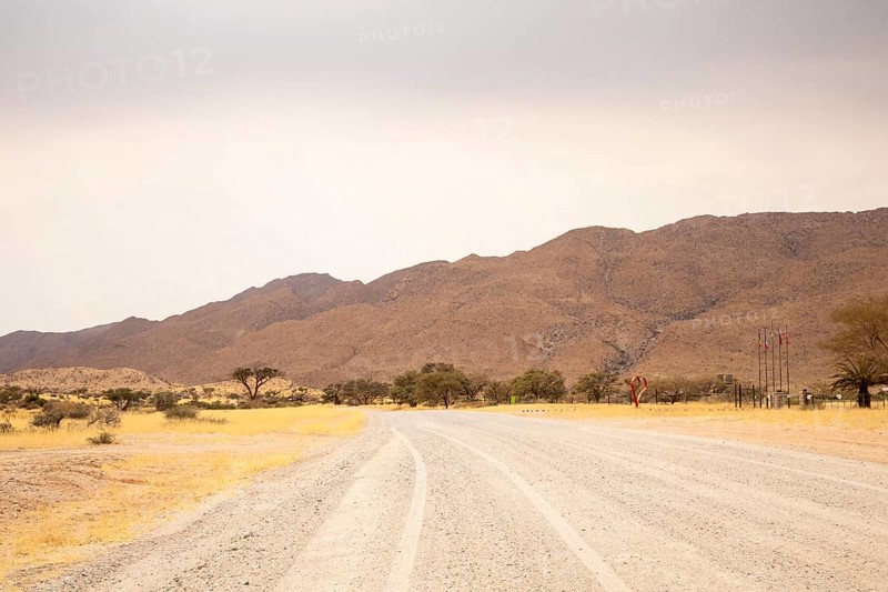 Dirt Road in Solitaire, Namibia, located on the edge of the Namib Desert, surrounded by dunes and mountain ranges