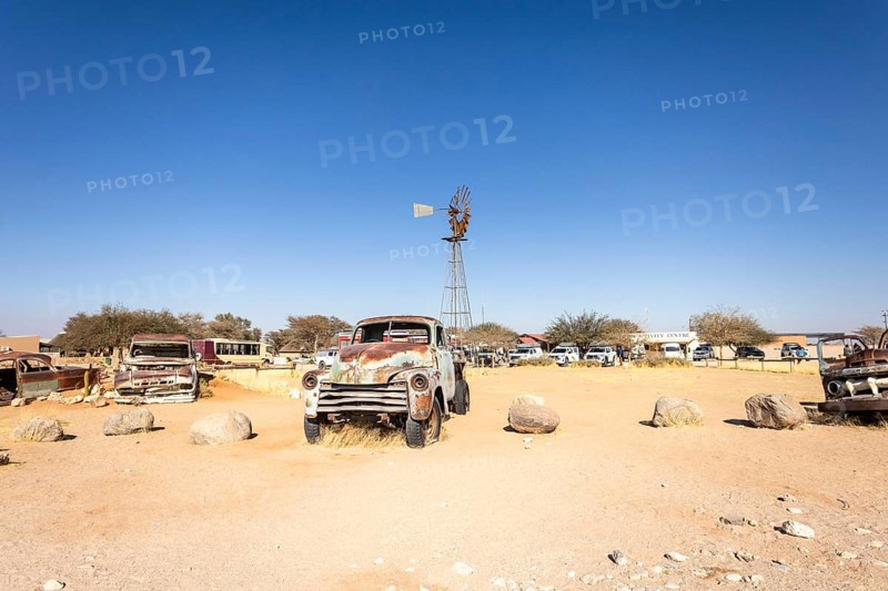 Solitaire's car graveyard in Namibia - 27 August, 2025: features rusted vintage cars near small desert buildings, set against dunes and mountains, capturing desert charm and isolation