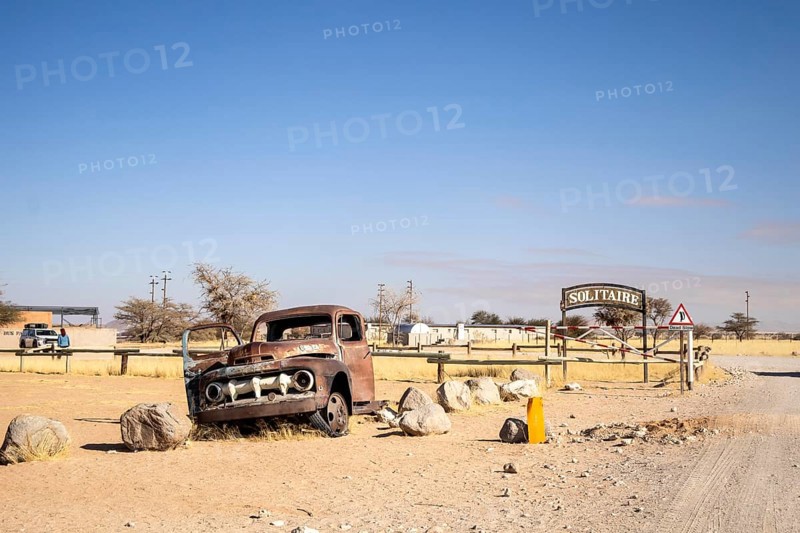 Solitaire's car graveyard in Namibia - 27 August, 2025: features rusted vintage cars near small desert buildings, set against dunes and mountains, capturing desert charm and isolation