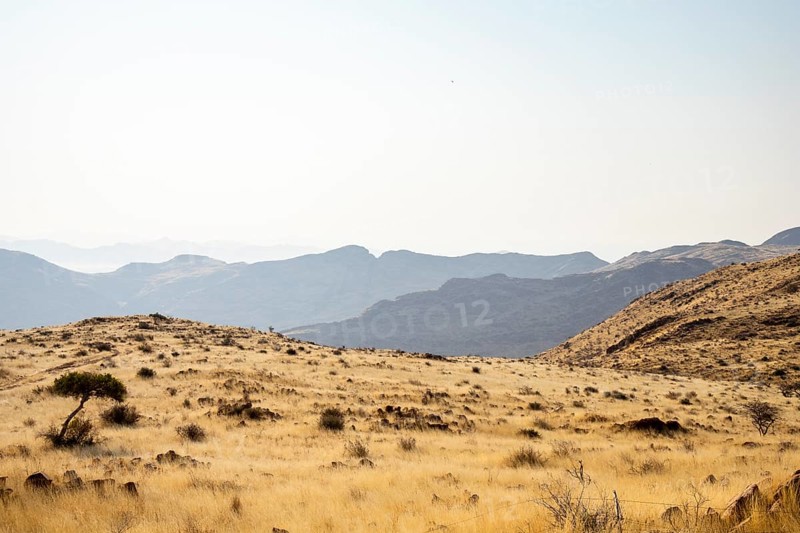 A picnic spot overlooks the vast Namib Desert from Spreetshoogte Pass, with hazy plains, rugged mountains