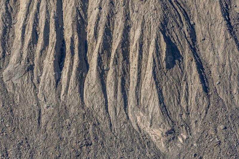 The earth's surface shows clear stripes and reliefs formed by erosion in dry regions. These natural patterns tell the geological history of the place. Gorner Glacier, Zermatt, Valais, Alps, Swiss
