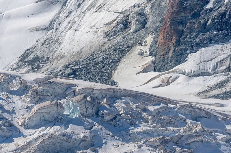 The mountainous landscape reveals impressive glaciers with ice formations and gleaming reflections in the morning light. Details of rocky outcrops add to the natural beauty. Gorner Glacier, Zermatt, Valais, Alps, Swiss