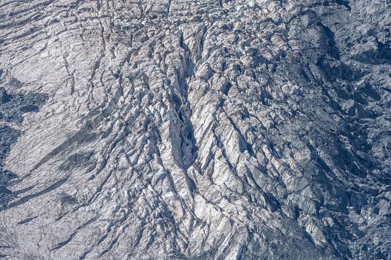 The mountainous landscape reveals impressive glaciers with ice formations and gleaming reflections in the morning light. Details of rocky outcrops add to the natural beauty. Gorner Glacier, Zermatt, Valais, Alps, Swiss