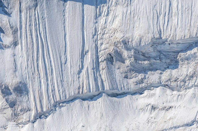Impressive scene shows lines and textures on residual ice cream in mountains. Daylight emphasises the beauty of this unique, cold landscape. Gorner Glacier, Zermatt, Valais, Alps, Swiss