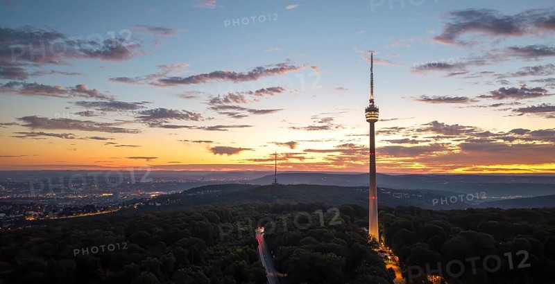 TV tower above wooded area at sunrise with dramatic sky, Stuttgart-Degerloch, Baden-Württemberg, Germany