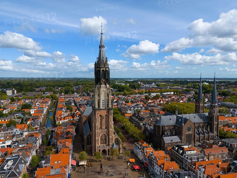 Historic church with high towers in a city with red roofs and clear skies, aerial view, Nieuwe Kerk, New Church, on the right Maria van Jessekerk, market square, Delft, Province of South Holland, Zuid-Holland, Netherlands