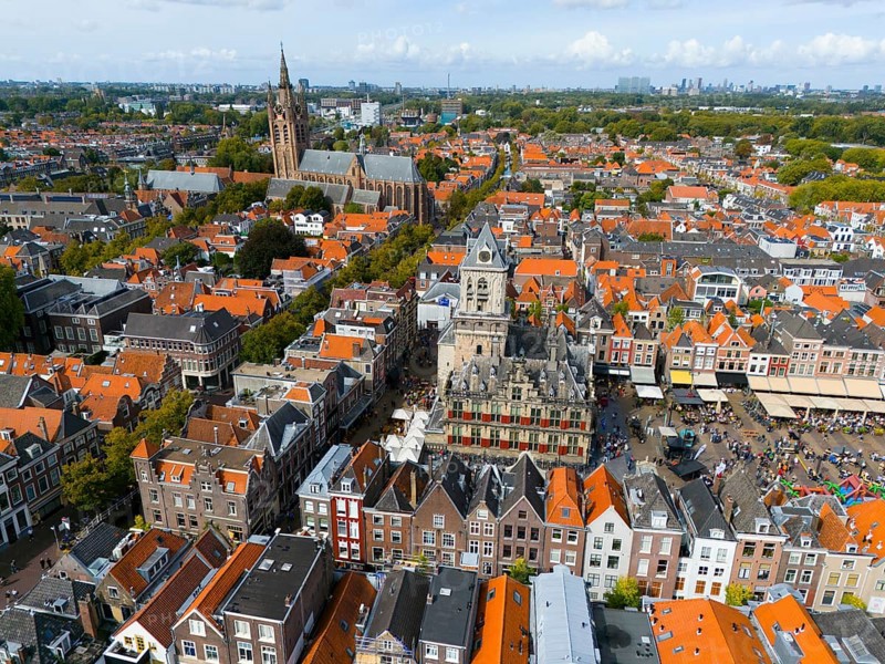 Market square with historic town hall surrounded by red roofs and lively atmosphere, aerial view, town hall, left in the background Oude Kerk, Old Church, market square, Delft, Province of South Holland, Zuid-Holland, Netherlands