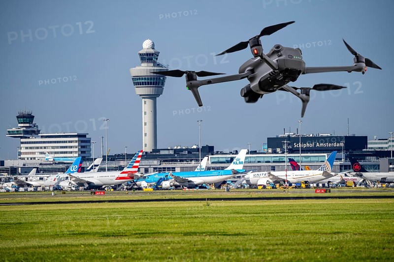 Symbolic image, photomontage, reconnaissance, spying with drones here at an airport, critical infrastructure, spying with camera drones