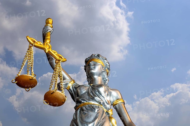 (Photomontage) Close-up of a Justitia in front of a blue sky