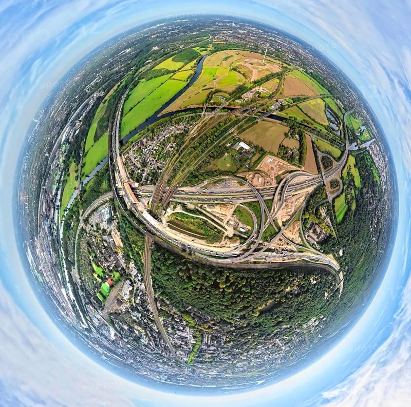 Aerial photo, Kaiserberg motorway junction with construction site, behind Styrumer Ruhrbogen energy park, earth globe, fisheye image, 360 degree image, tiny world, little planet, fisheye image, Duissern, Duisburg, Ruhr area, North Rhine-Westphalia, Germany, motorway, construction work, construction area, construction site, building plots, construction, construction project, construction site, DE, Europe, fisheye lens, fisheye lens, large construction site, Little Planet, aerial view, aerial photography, aerial photography, new construction, road traffic, super wide angle lens, Tiny World, overview, bird's eye view, globe, birds-eyes view, fisheye lens, insta360 camera, overview