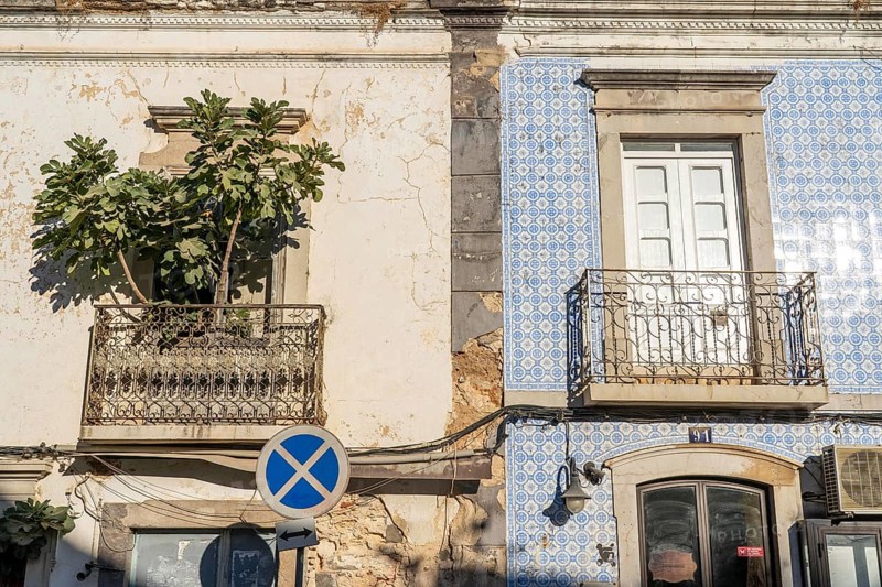 Facade of buildings decorated with tiles, azulejos, coloured tiles on facades, in Tavira, old town, in the east of the Algarve, Portugal
