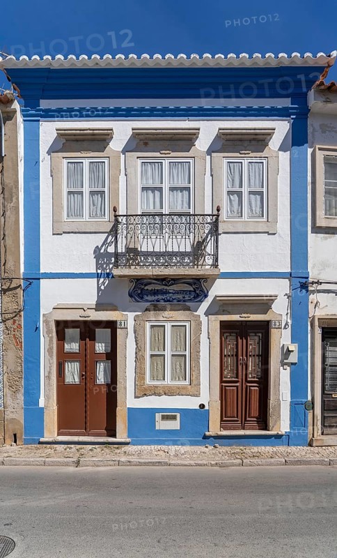 Facade of buildings decorated with tiles, azulejos, coloured tiles on facades, in Tavira, old town, in the east of the Algarve, Portugal