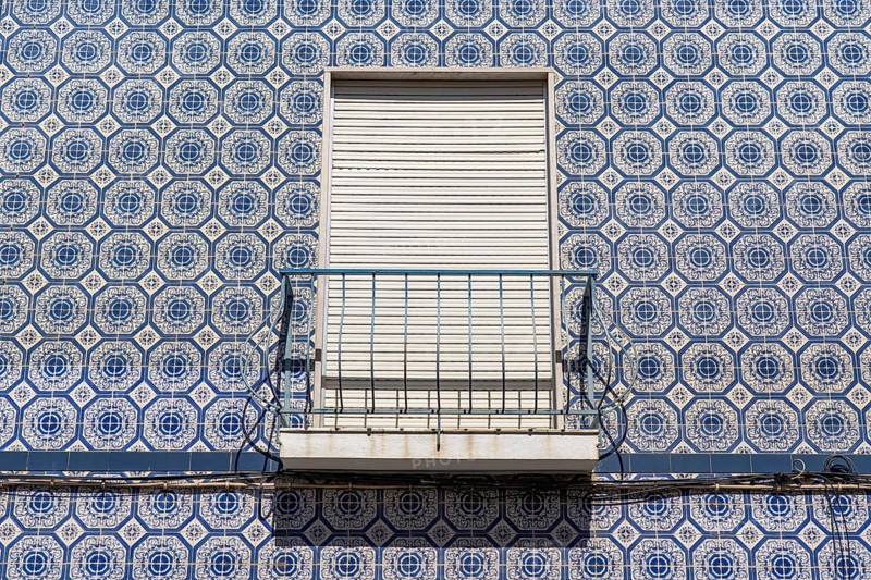 Facade of buildings decorated with tiles, azulejos, coloured tiles on facades, in Tavira, old town, in the east of the Algarve, Portugal