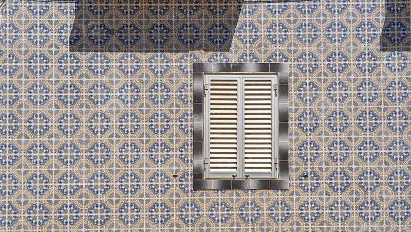 Facade of buildings decorated with tiles, azulejos, coloured tiles on facades, in Tavira, old town, in the east of the Algarve, Portugal