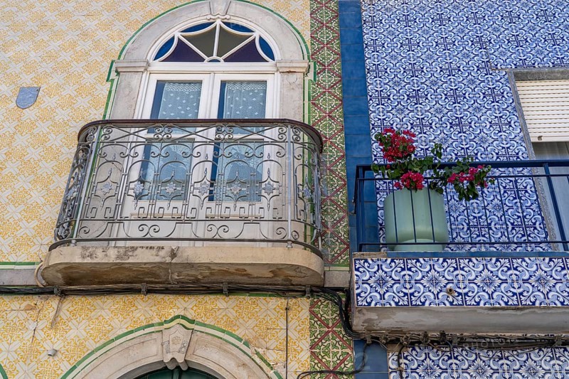 Facade of buildings decorated with tiles, azulejos, coloured tiles on facades, in Tavira, old town, in the east of the Algarve, Portugal
