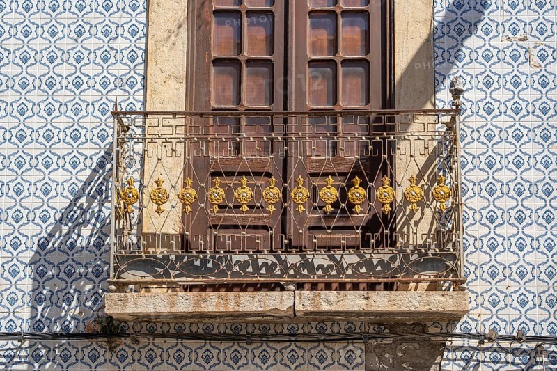 Facade of buildings decorated with tiles, azulejos, coloured tiles on facades, in Tavira, old town, in the east of the Algarve, Portugal