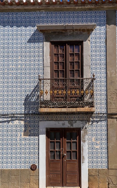 Facade of buildings decorated with tiles, azulejos, coloured tiles on facades, in Tavira, old town, in the east of the Algarve, Portugal
