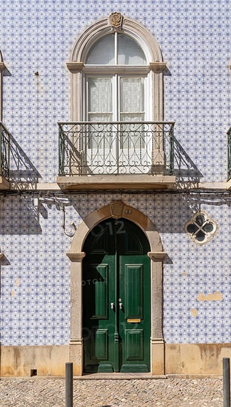 Facade of buildings decorated with tiles, azulejos, coloured tiles on facades, in Tavira, old town, in the east of the Algarve, Portugal