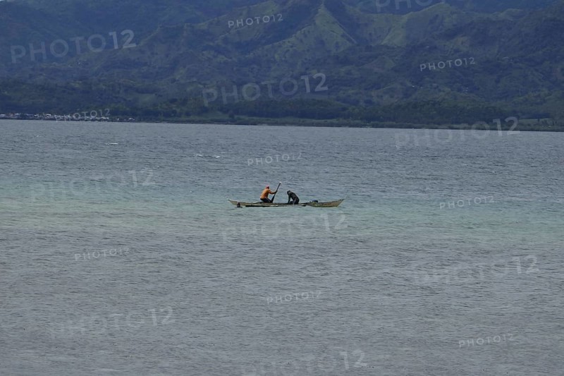 Two fishermen fishing off the coast, Negros Occidental, Philippines