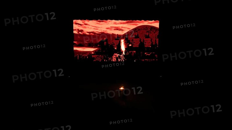 Dancers from Fire of Anatolia perform a choreography in red costumes with a historic stone wall projected on stage. The troupe combines Anatolian folk traditions with modern stage techniques and has performed in more than 85 countries, Gaziantep, Gaziantep, Türkiye