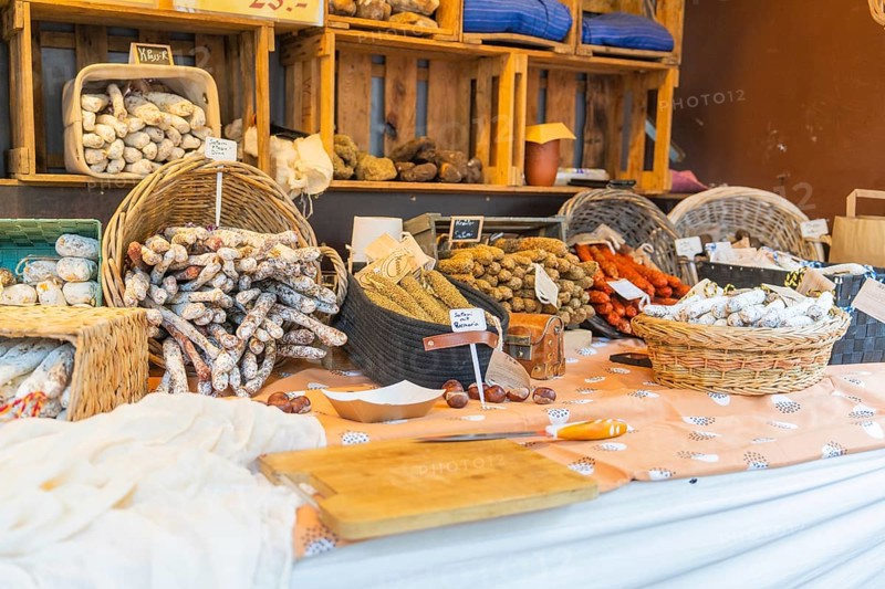 Various types of sausage presented on a market stall with baskets and wooden crates, Sindelfingen, Böblingen district, Germany
