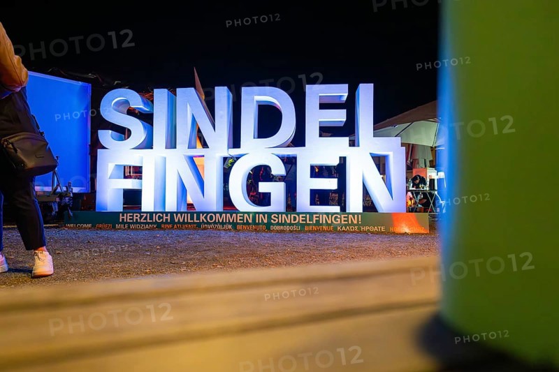 Illuminated welcome sign at night with colourful surroundings and festive atmosphere, Sindelfingen, Böblingen district, Germany