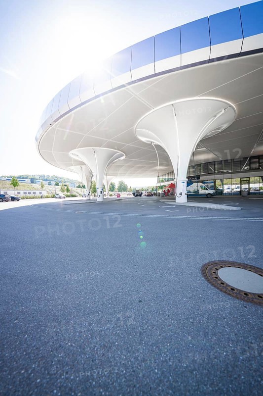 Curved, modern multi-storey car park structure with columns in daylight, Munich, Germany