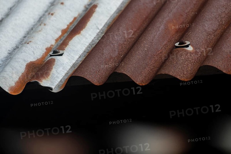 Close-up of a rusty, corrugated metal roof with brown and gray textures, Gazipur, bangladesh