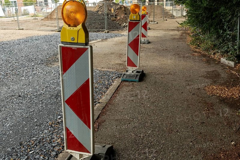 Borken, NRW, Germany, Red and white striped warning posts with flashing orange lights marking a closed road during construction