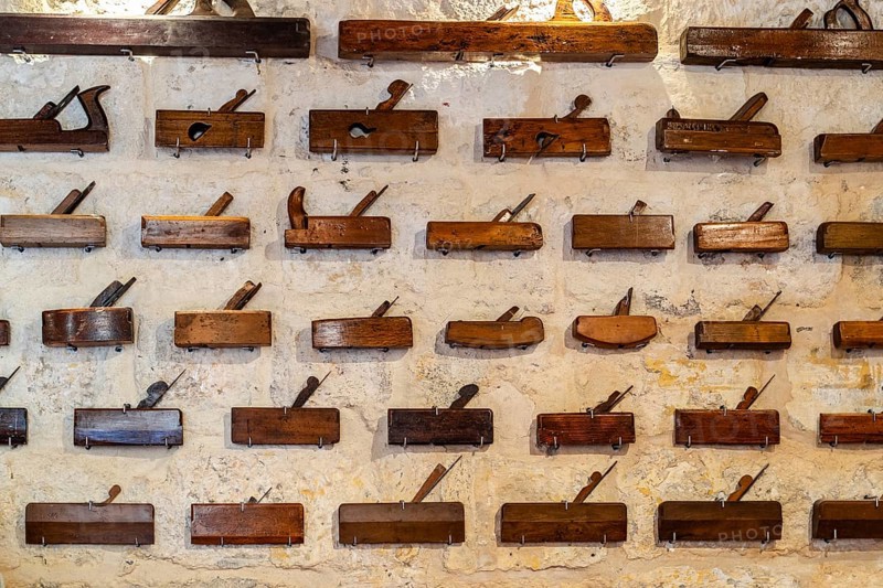 Plenty of different carpenter's planes exhibited on wall, Malta
