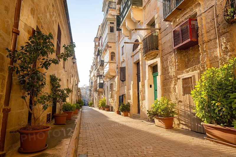 Street with wondeful historic houses with colorful wooden balconies in La Valletta, capital city of Malta