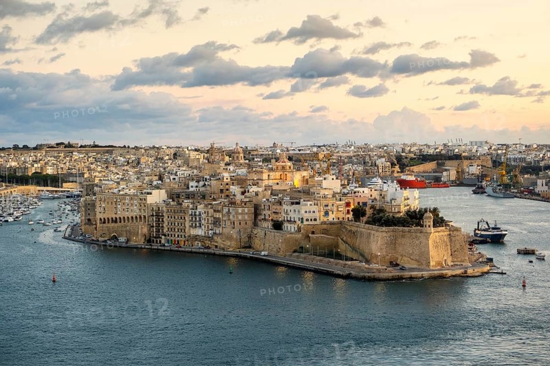 Beautiful sunset view of Valletta with Saint Angelo Fortress, capital city of Malta