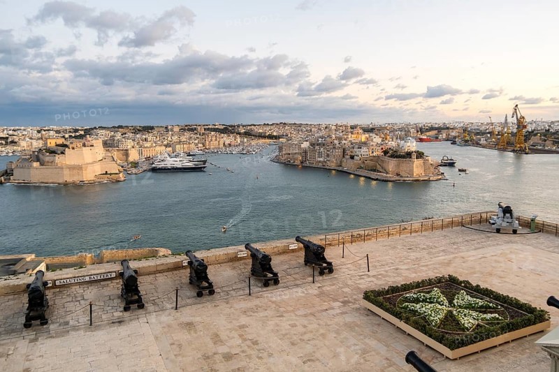 Beautiful sunset view of Valletta with a cannons in the foreground, capital city of Malta