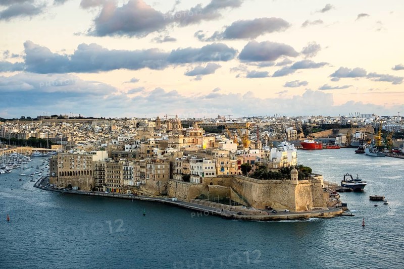Beautiful sunset view of Valletta with Saint Angelo Fortress, capital city of Malta