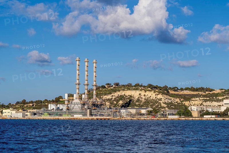 Waterfront power station against blue sky, with copy space, near to Marsaxlokk, Malta