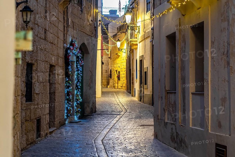 Charming illuminated medieval streets of Rabat Mdina in the evening Malta