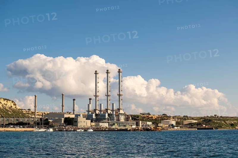 Waterfront power station against blue sky, with copy space, near to Marsaxlokk, Malta