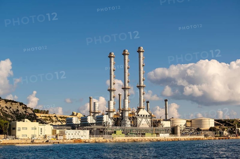 Waterfront power station against blue sky, with copy space, near to Marsaxlokk, Malta