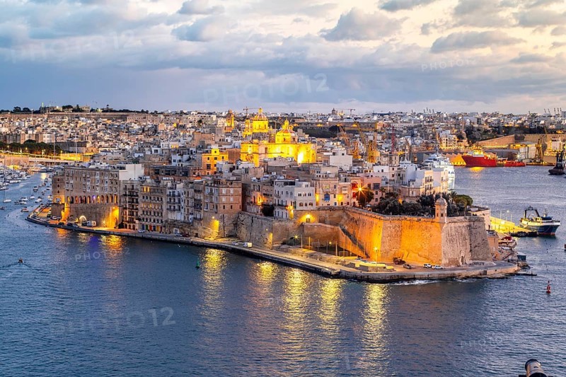 Beautiful evening view of illuminated Valletta, Birgu with Saint Angelo Fortress, capital city of Malta