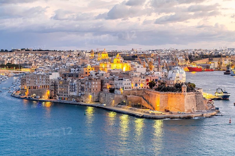 Beautiful evening view of illuminated Valletta, Birgu with Saint Angelo Fortress, capital city of Malta