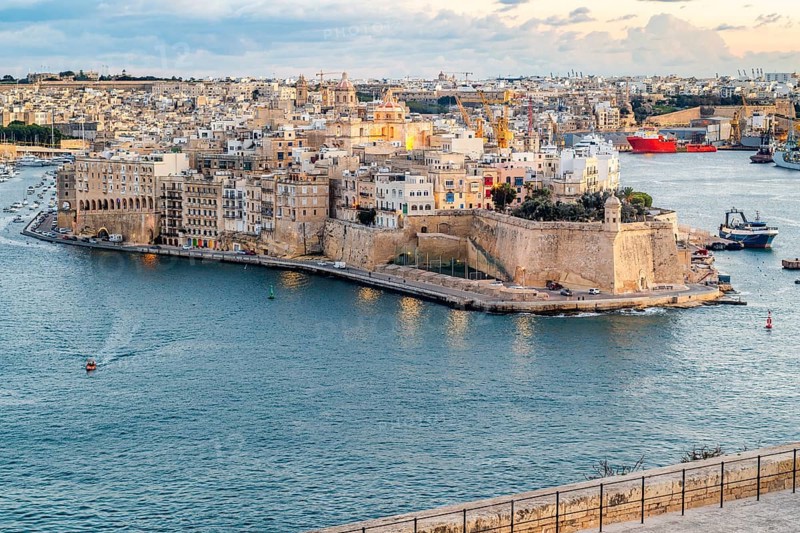 Beautiful sunset view of Valletta city with Saint Angelo Fortress, capital city of Malta