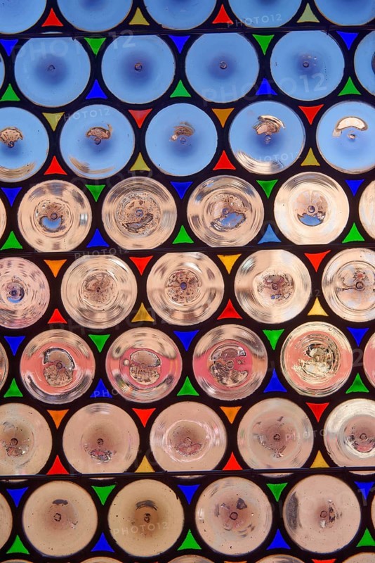 Antique window with round panes in Siena