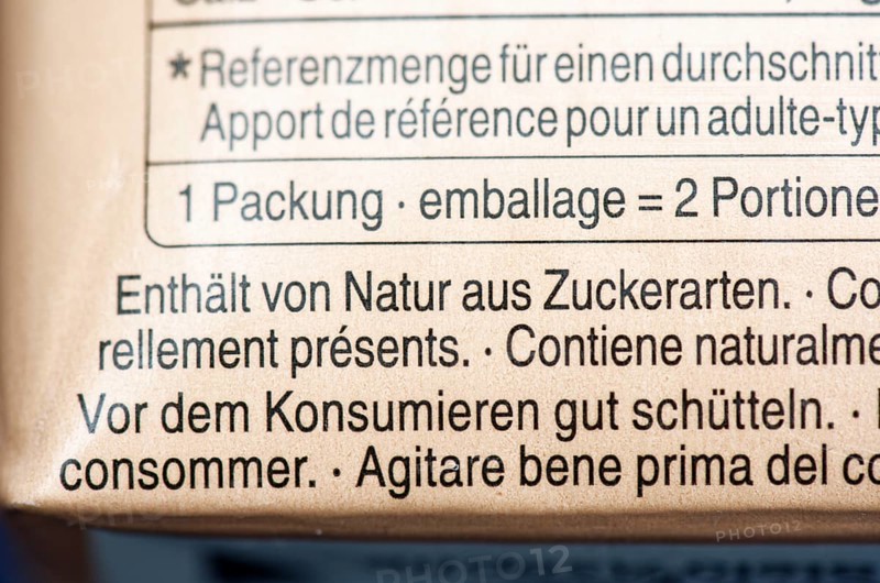 List of ingredients on a carton of oat milk. Focus on indication of sugar content