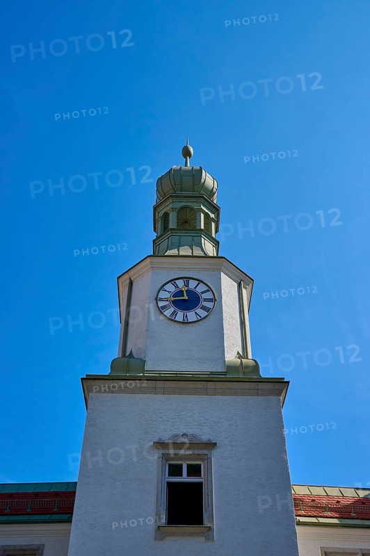 Historic clock tower against a bright blue sky. Baroque architecture with clear lines, brewhouse am Schloss, Regensburg, Bavaria, Germany