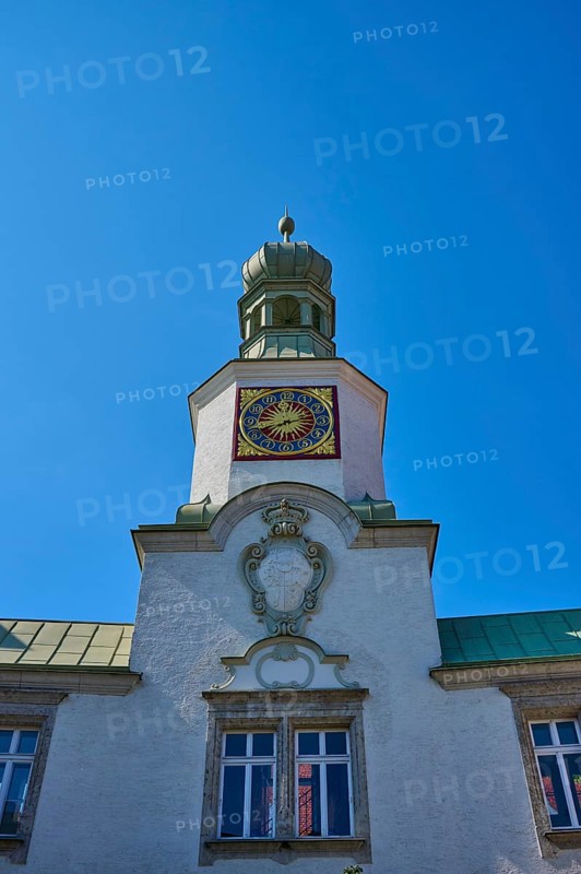 Tower clock on a historic building under a clear blue sky. Impressive baroque architecture, brewhouse am Schloss, Regensburg, Bavaria, Germany