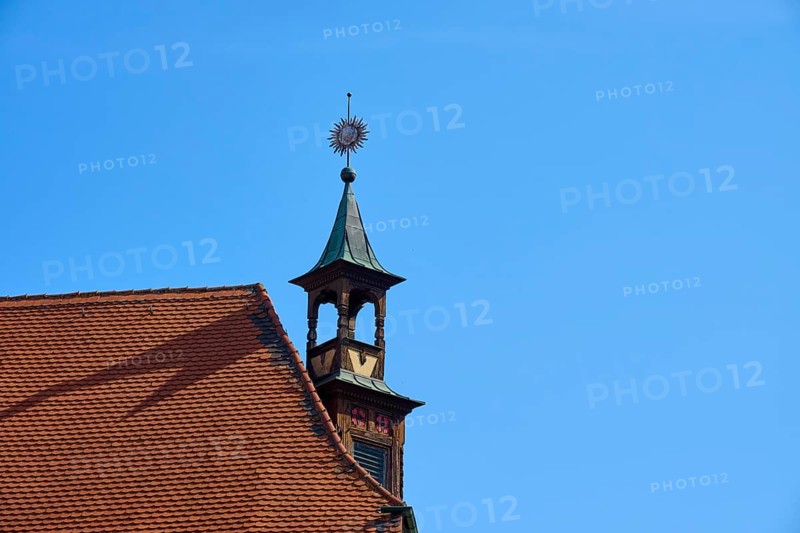 Historic rooftop with tower and weather vane under a clear sky, Regensburg, Bavaria, Germany